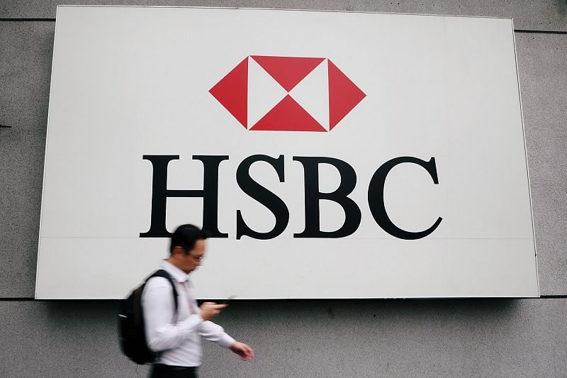 A man walks past a logo of HSBC at its headquarters in Kuala Lumpur, Malaysia. (Reuters Photo)