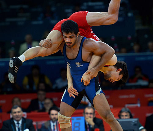 File Photo - India's Sushil Kumar (in blue) fights with Kazakistan Akzhurek Tanatarov in their Men's 66kg Freestyle Semifinal match at the Olympic Games in London on 12 August 2012. IOC leaders have dropped wrestling for the 2020 Games in a surprise decision to scrap one of the oldest sports on the Olympic program. The IOC executive board decided Tuesday, Feb. 12, 1013 to retain modern pentathlon  the event considered most at risk  and remove wrestling instead from its list of core sports PTI Photo