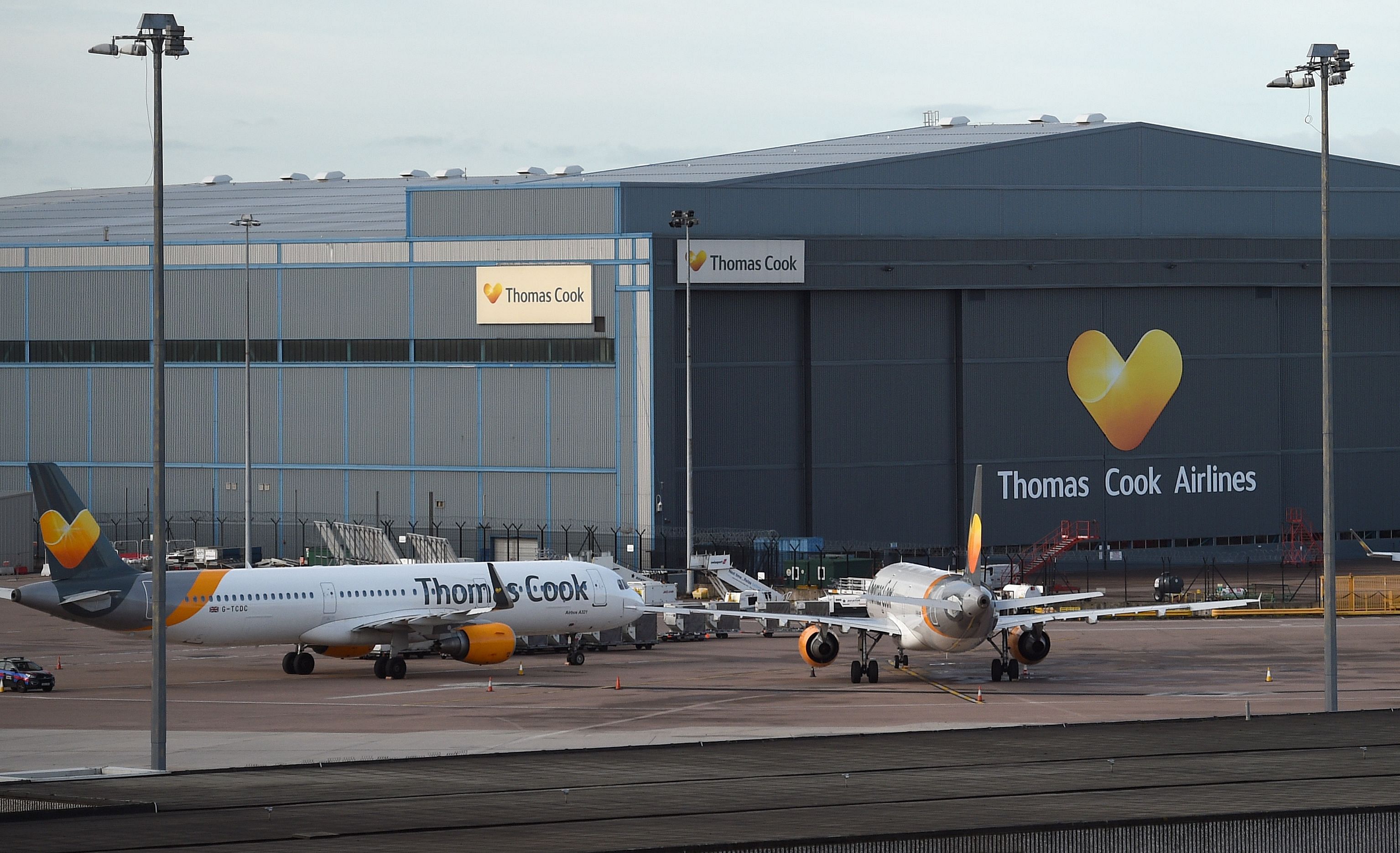 Thomas Cook passenger aircraft stand at on the tarmac outside the company's hangar at Manchester Airport in Manchester, northern England. (AFP Photo)
