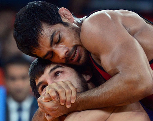 File photo of grappler Sushil Kumar overpowering his rival during a freestyle wrestling match. PTI