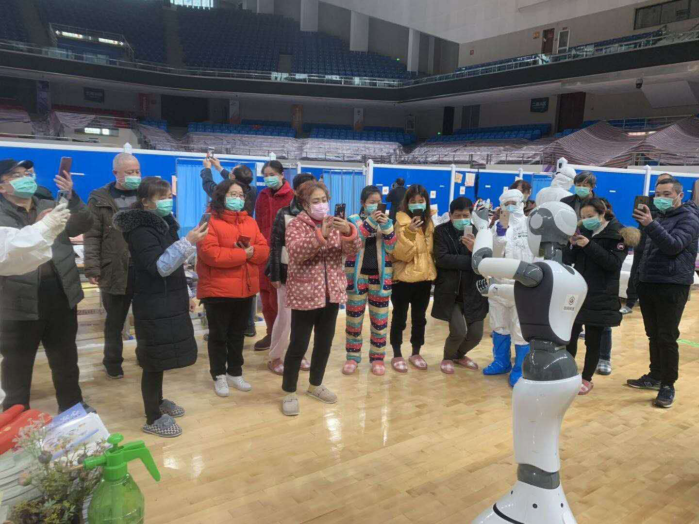A handhout picture provided by CloudMinds shows Wuhan smart field hospital staff looking at a XR1. (AFP Photo