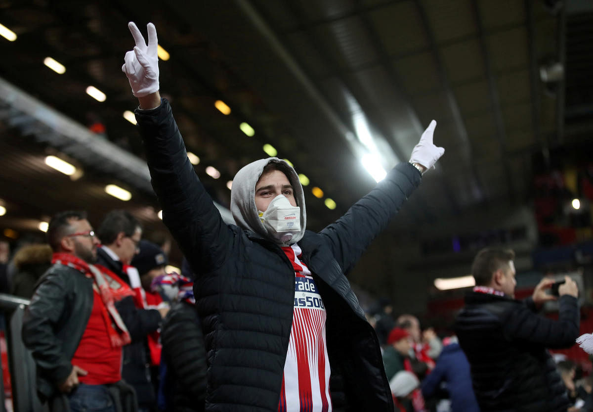 An Atletico Madrid fan wearing a face mask inside the stadium before the match as the number of coronavirus cases grow around the world. Reuters/File