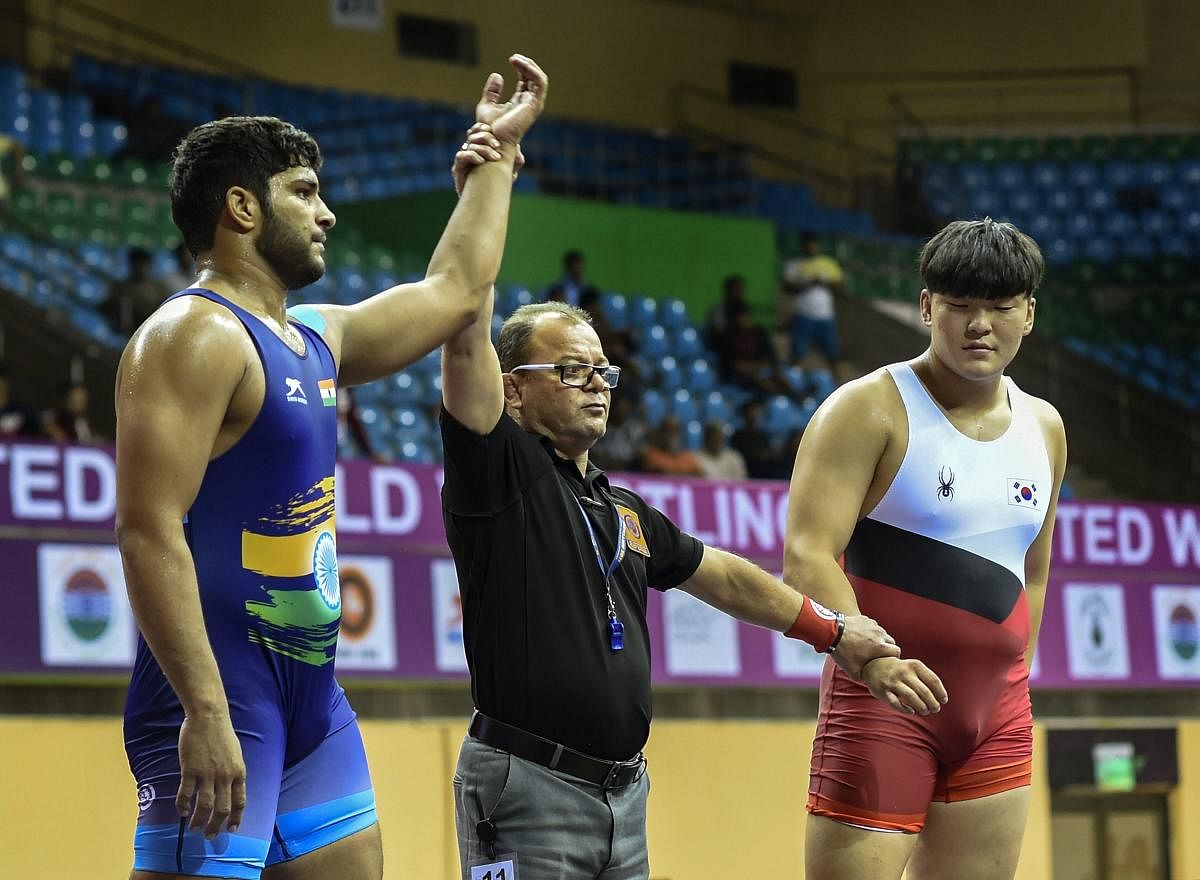 Indian wrestler Viresh Kundu (blue) being declared winner in the final of the 97 kg category of the Junior Asian Wrestling Championship 2018 against Korea's Jeongyul Kwon, in New Delhi on Tuesday. (PTI Photo/Atul Yadav)