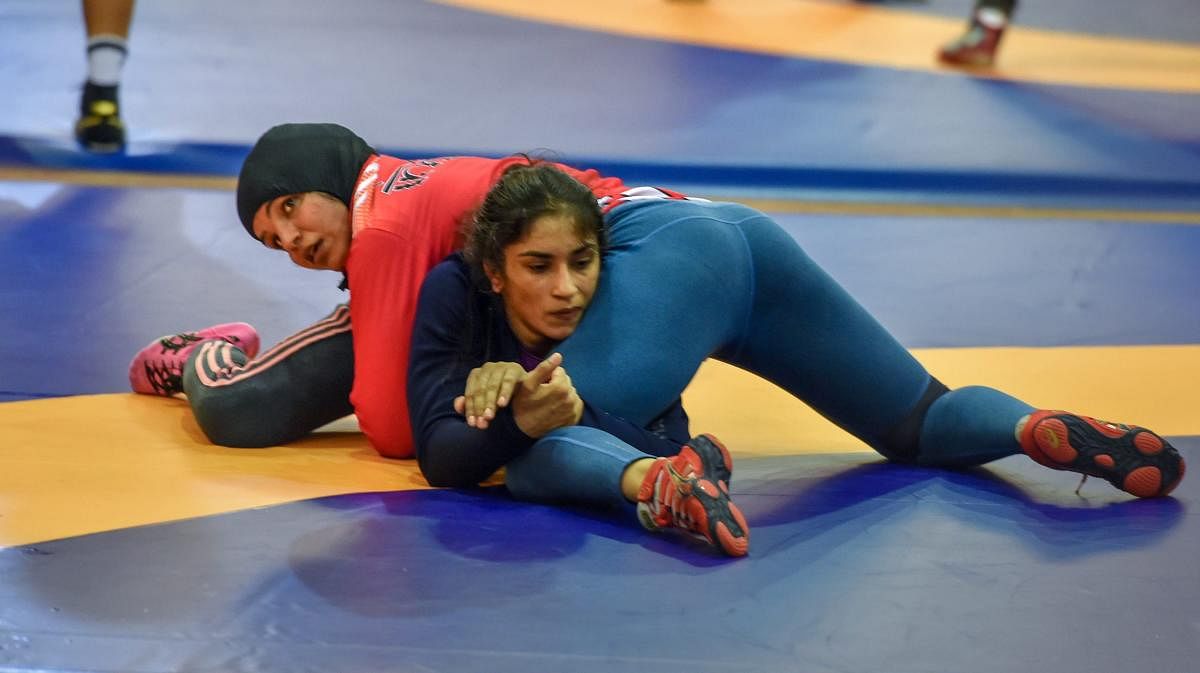 SLUGGING IT OUT Indian wrestlers Sakshi Malik (red) with Vinesh Phogat during a training session in Jakarta on Friday. PTI