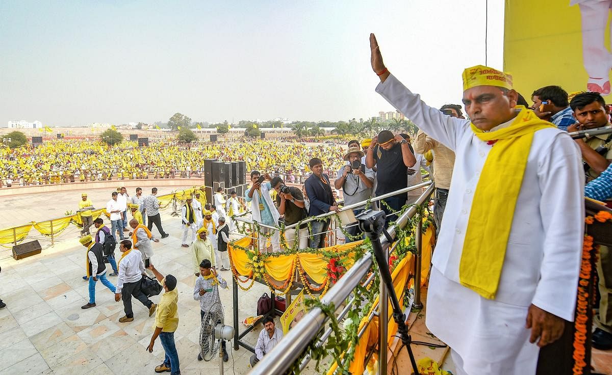 SBSP president Om Prakash Rajbhar waves at supporters during a rally to mark the 16th foundation day of the party at Ramabai Rally Sthal in Lucknow on Saturday. PTI