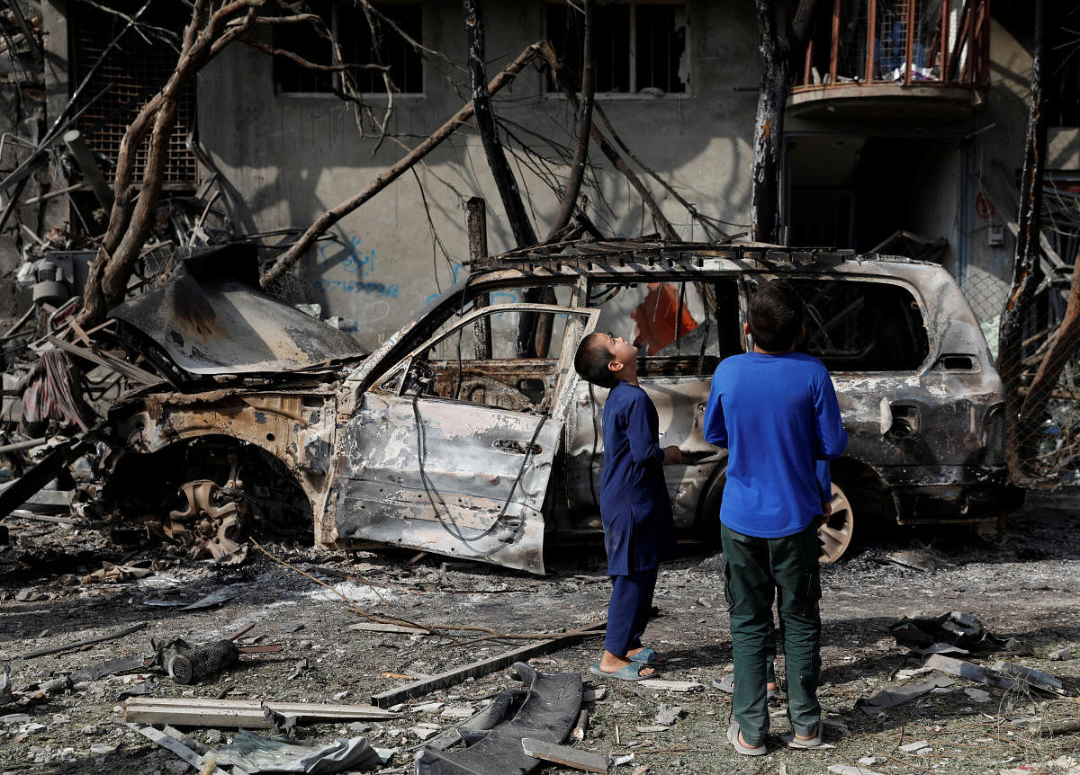 Afghan boys look at the site of Sunday's attack in Kabul, Afghanistan (Reuters Photo)