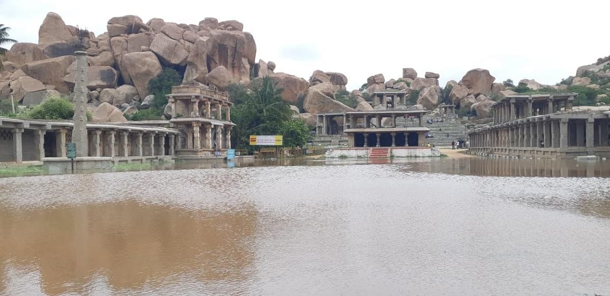 A swollen Tungabhadra River inundated the Rathabeedhi located in front of Basava Mantapa in Hampi on Sunday. DH Photo/Shashikanth Shembelli