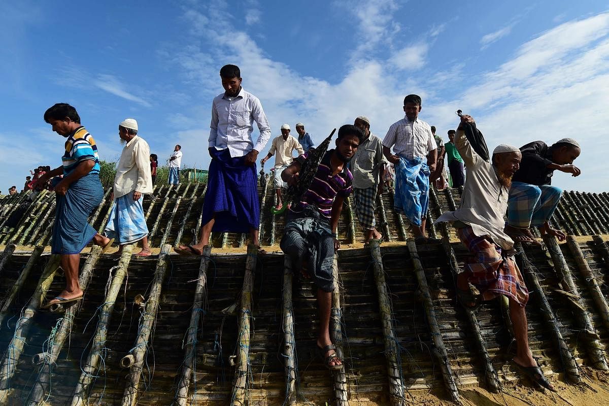 Rohingya refugees arrive to attend a ceremony organised to remember the second anniversary of a military crackdown that prompted a massive exodus of people from Myanmar to Bangladesh, at the Kutupalong refugee camp in Ukhia on August 25, 2019. (Photo by A