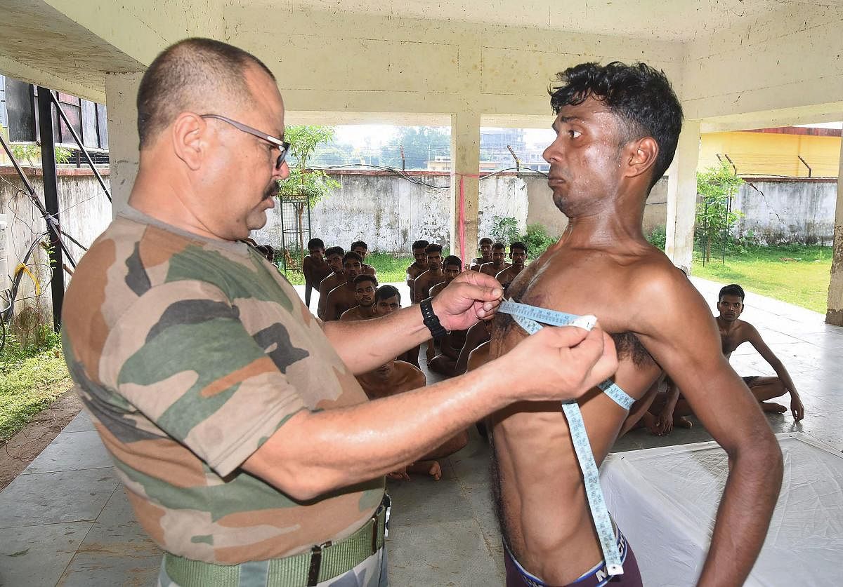 A candidate gives measurements during army recruitment. PTI file photo