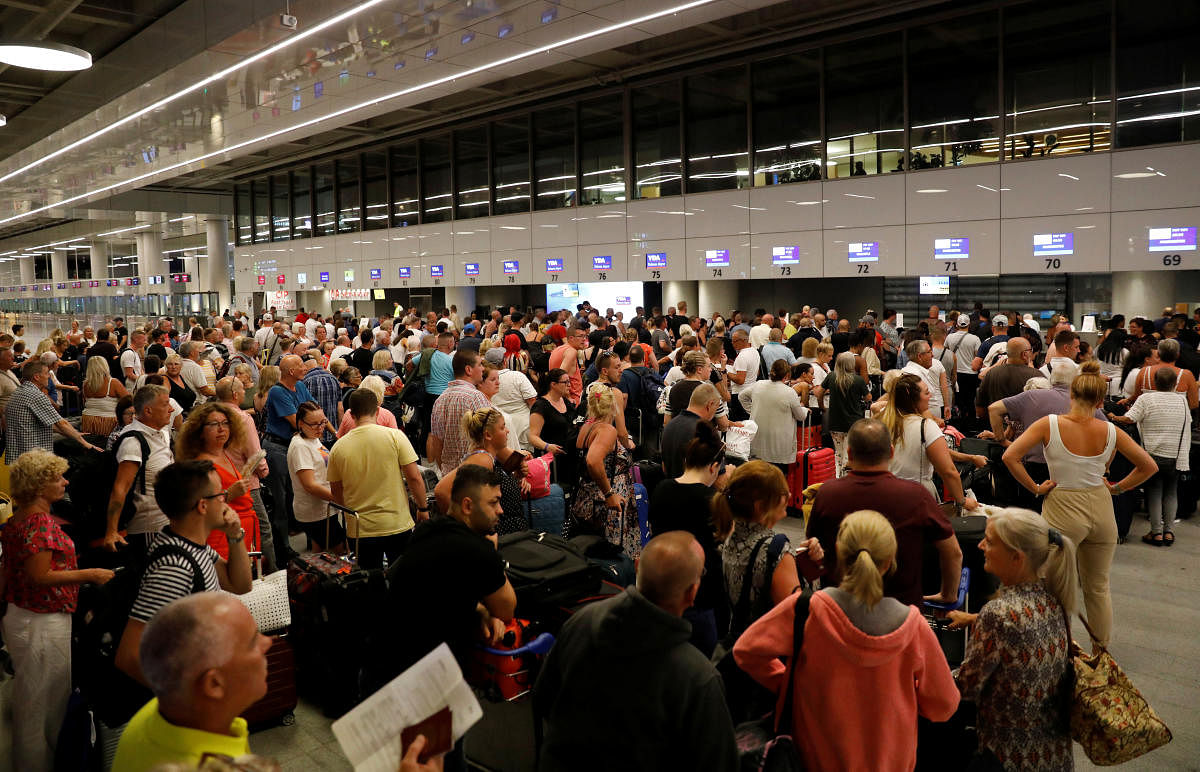 British passengers queue up at a check-in service at Dalaman Airport after Thomas Cook, the world's oldest travel firm, collapsed stranding hundreds of thousands of holidaymakers around the globe. (Reuters Photo)