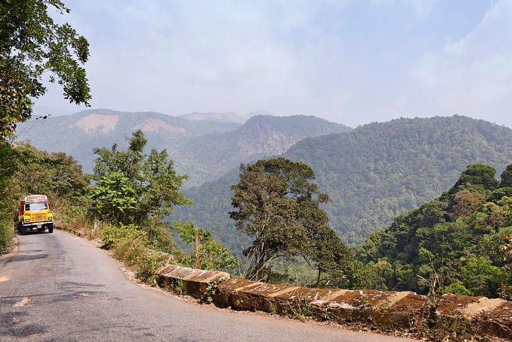 Indian Tata truck driving on the Hill Highway ( State Highway 59) near Boys Town , a place located 15 km north of Mananthavady, a town in the Wayanad district of Kerala. (iStock photo)