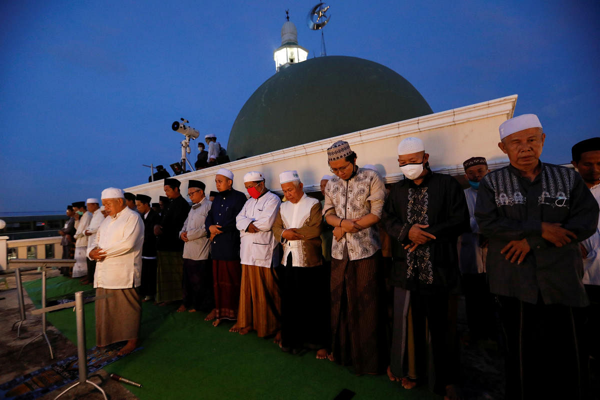Muslim men perform evening prayers on the roof of Al Musariin mosque after they tried to look for the new moon to mark the first day of Ramadan. Reuters