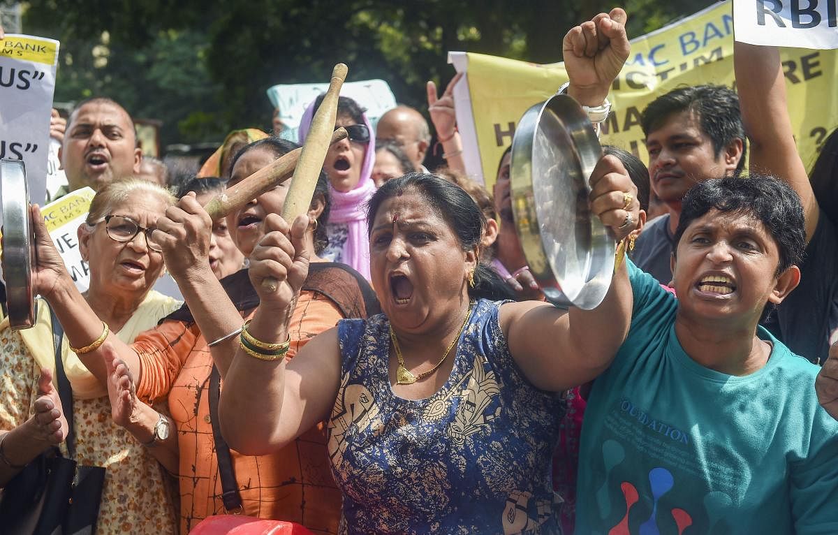 PMC bank account holders raise slogans as they protest outside the RBI office in Mumbai. PTI