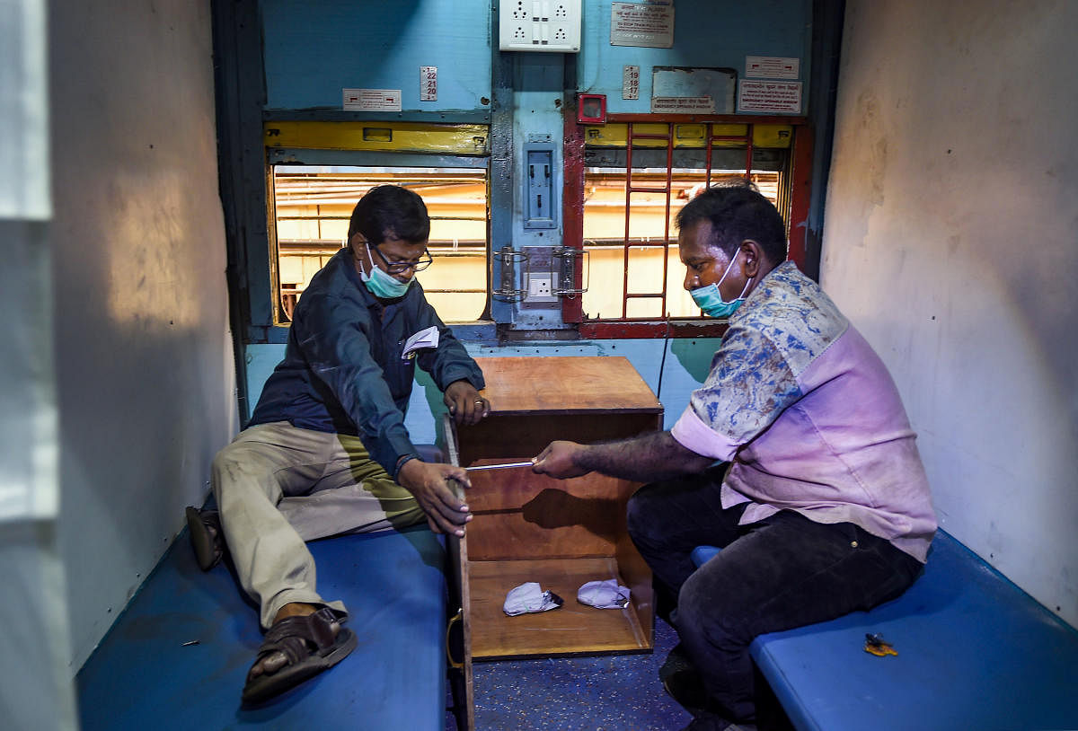Workers of Southern Railway prepare to install beds inside a train coach, in Chennai, Monday, March 30, 2020. Credit: PTI Photo