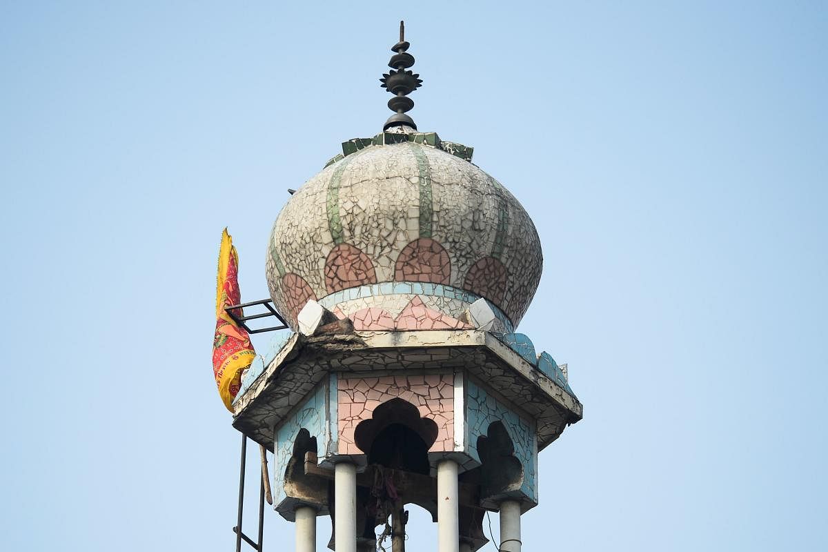 A minaret of the burnt-out mosque following clashes between people supporting and opposing a contentious amendment to India's citizenship law, in New Delhi. (AFP Photo)