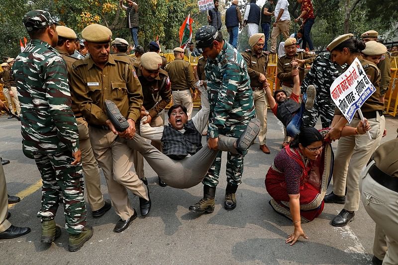 Police detains activists of the youth wing of India's main opposition Congress party during a protest demanding the resignation of Home Minister Amit Shah following last week's clashes between people demonstrating for and against a new citizenship law, in New Delhi. (Reuters Photo)