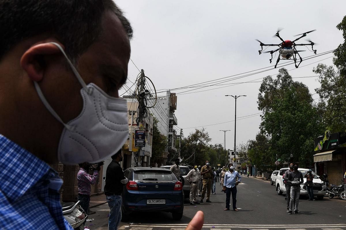 A drone sprays disinfectant chemicals to sanitise an area during a government-imposed nationwide lockdown as a preventive measure against the COVID-19 coronavirus (AFP Photo)
