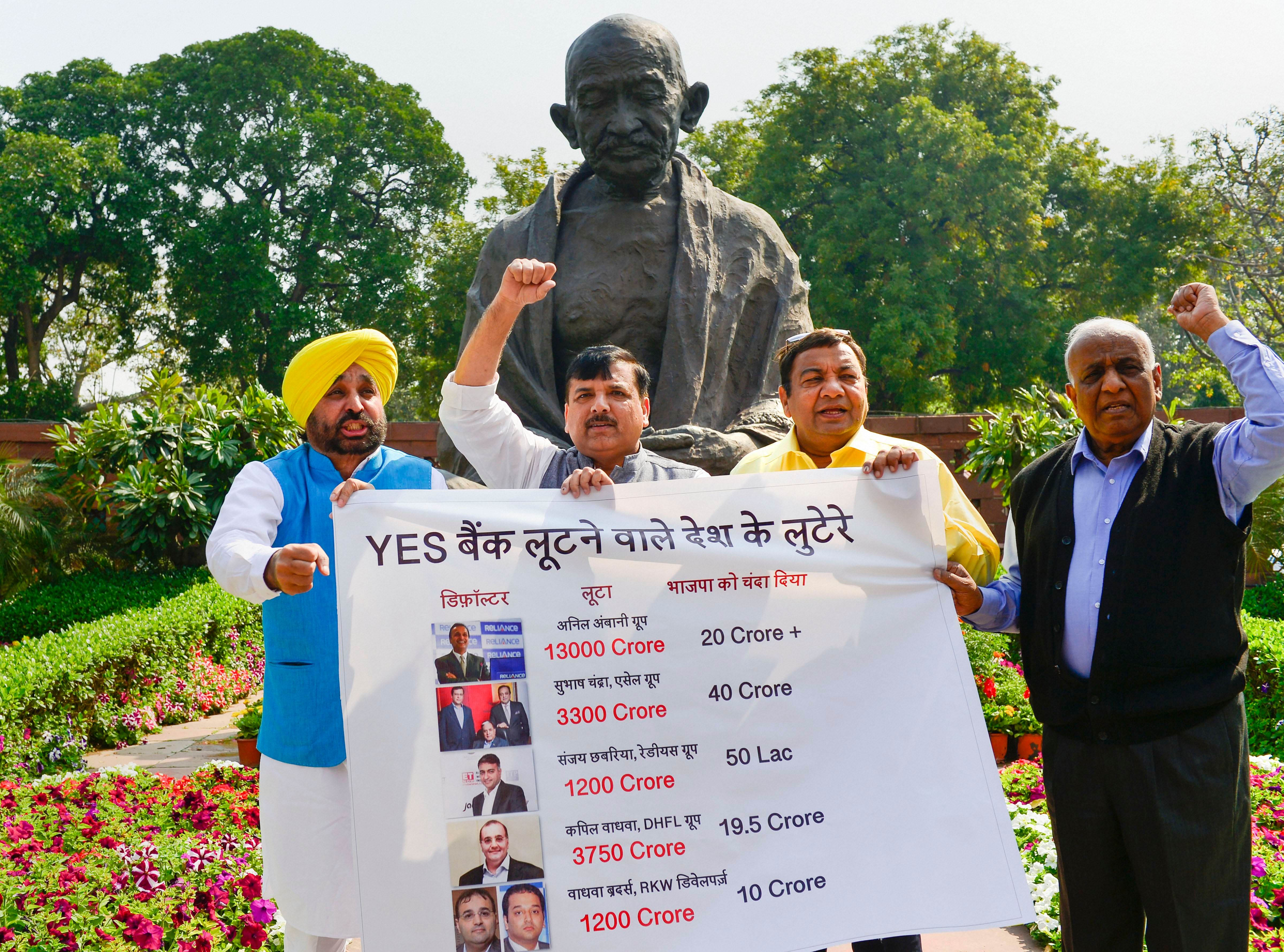 Aam Aadmi Party MPs Bhagwant Mann, Sanjay Singh, Sushil Gupta and N D Gupta raise slogans during a protest over the Yes Bank scam, at Parliament during the ongoing Budget Session, in New Delhi. (PTI Photo)