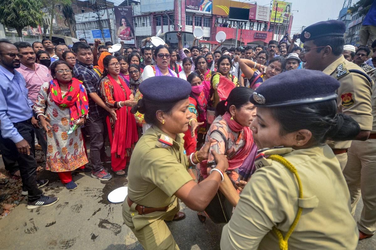 Police personnel detain adhoc teachers during their demonstration over various demands, in Agartala, Tuesday, March 17, 2020. (PTI Photo)