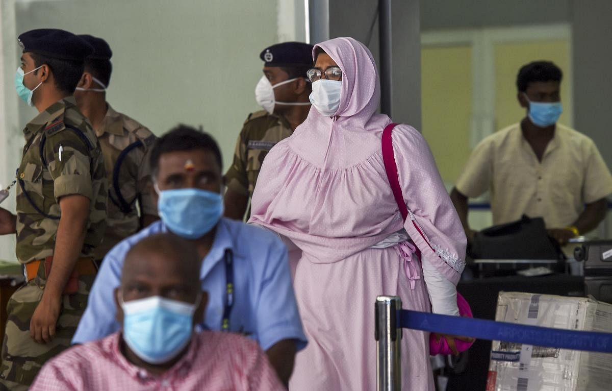 Passengers wear protective masks, in wake of the deadly novel coronavirus, at the airport in Chennai, Friday, March 6, 2020. (PTI Photo)