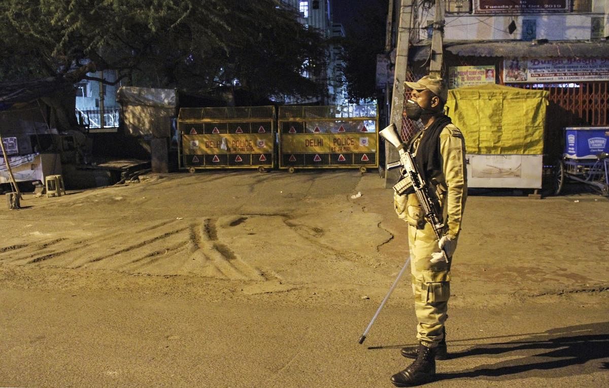 A police personnel stands guard outside a sealed locality (PTI Photo)