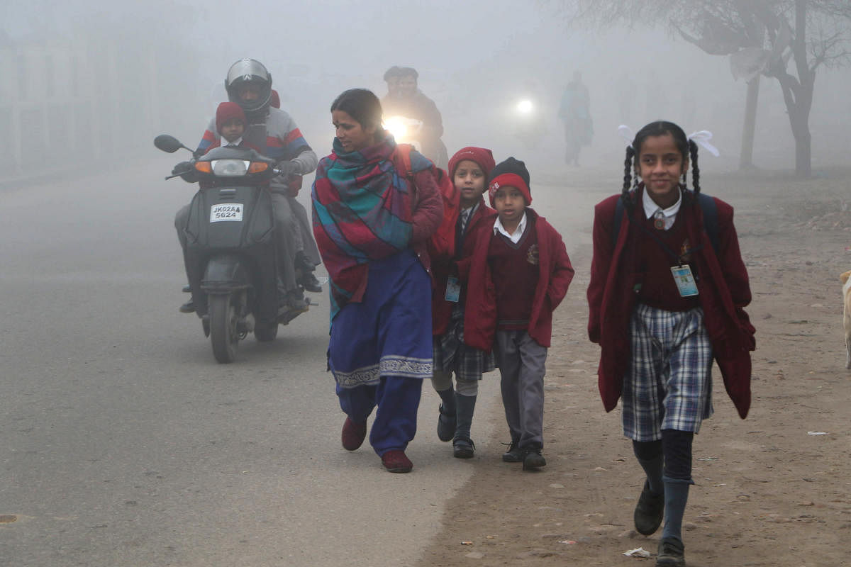 Children on their way to school amid during a cold and foggy morning, on the outskirts of Jammu, Thursday. Jan. 16, 2020. (PTI Photo)