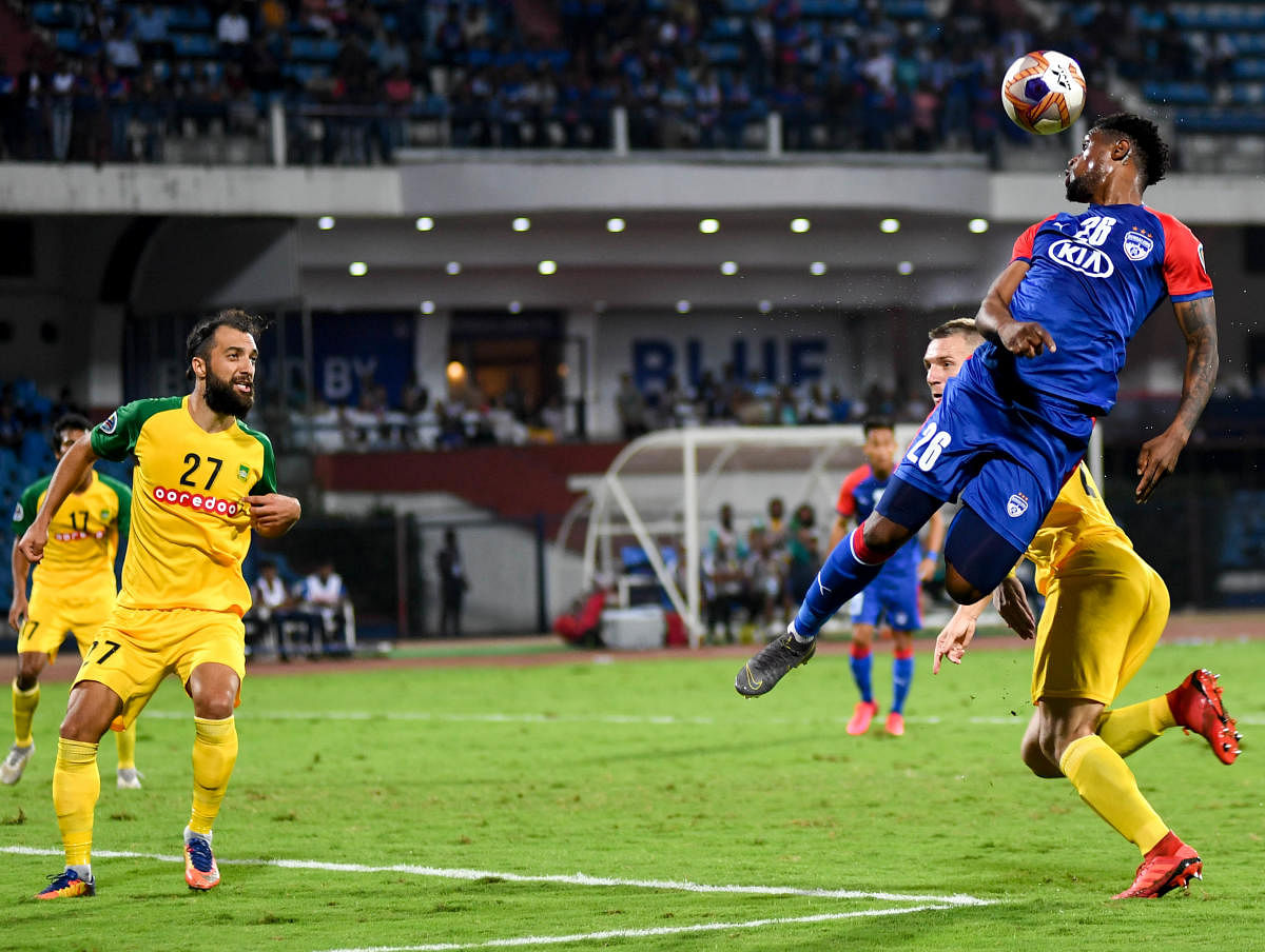 Bengaluru FC’s Deshorn Brown (right) attempts a header during their AFC Cup game against Maziya S&RC at the Sree Kanteerava Stadium on Wednesday. DH Photo/ B H