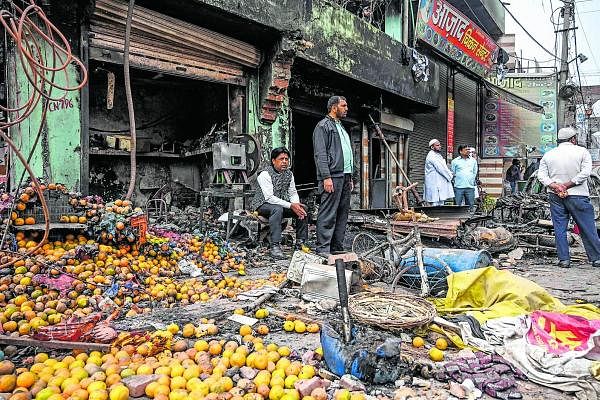 People look out near a burnt-out and damaged shop at the riot-hit area following clashes between people supporting and opposing a cententious amendment to India's citizenship law, in New Delhi on February 27, 2020. (AFP Photo)