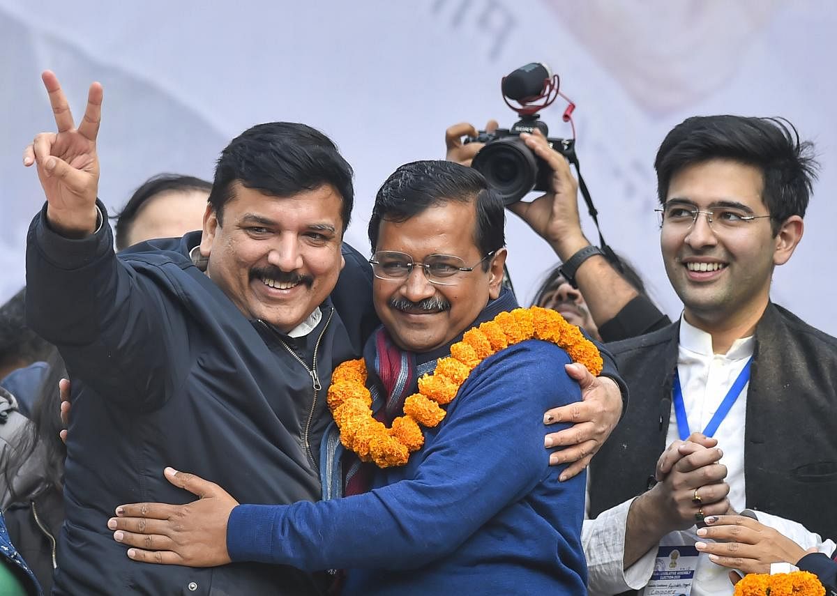 Delhi CM and AAP convenor Arvind Kejriwal hugs party leader Sanjay Singh during his address to supporters after party's victory in the State Assembly polls, at AAP office in New Delhi, Tuesday, Feb. 11, 2020. (PTI Photo)