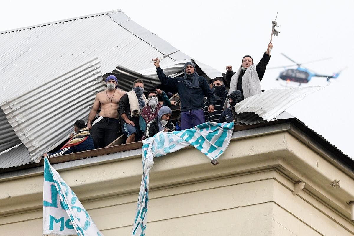 Inmates protest on the roof of Villa Devoto prison demanding measures to prevent the spread of the Covid-19 coronavirus, after a case was reported inside the detention center, in Buenos Aires. AFP