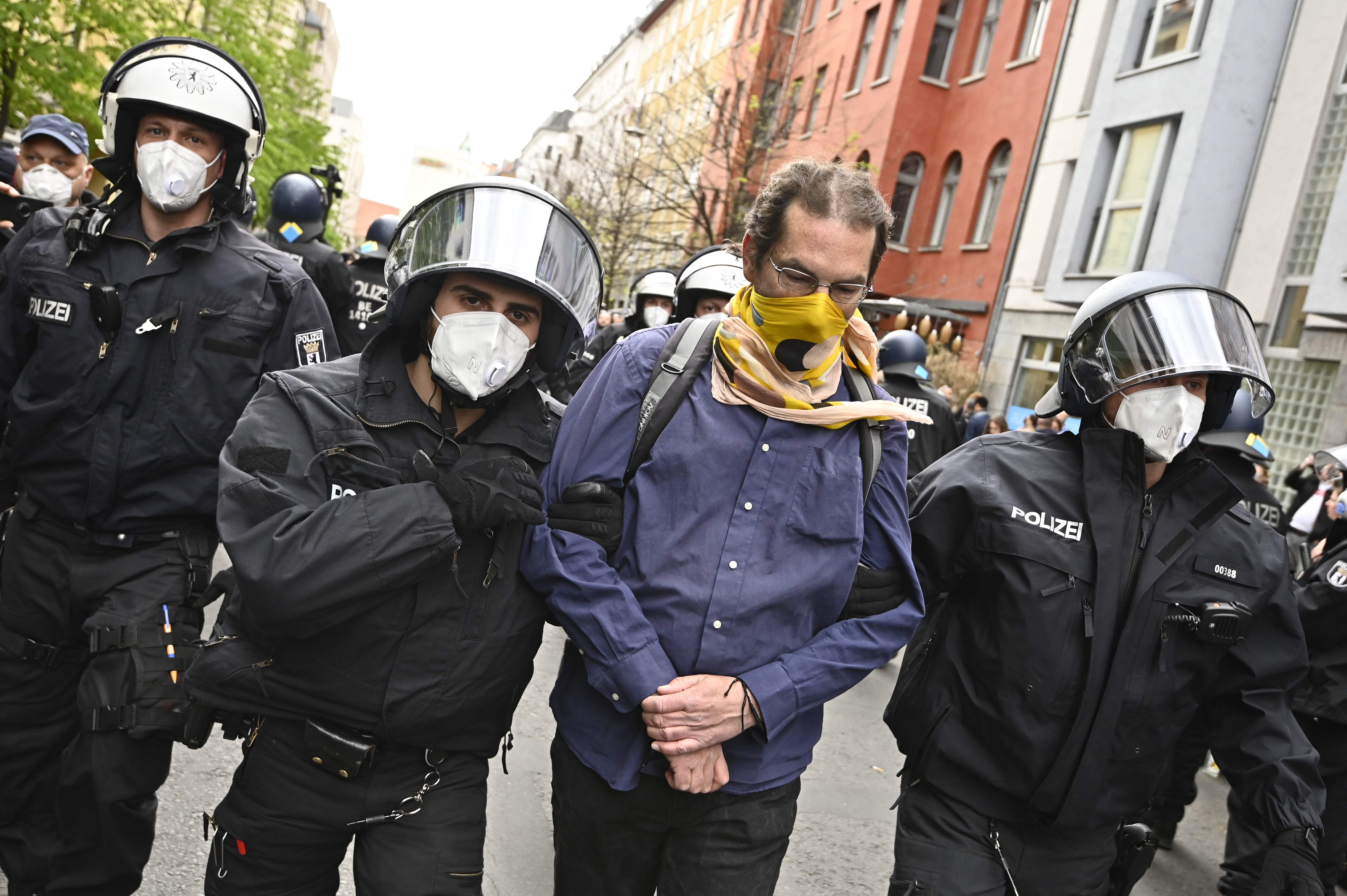 Police remove a demonstrator during a protest against the Corona restrictions in Berlin. (AFP Photo)