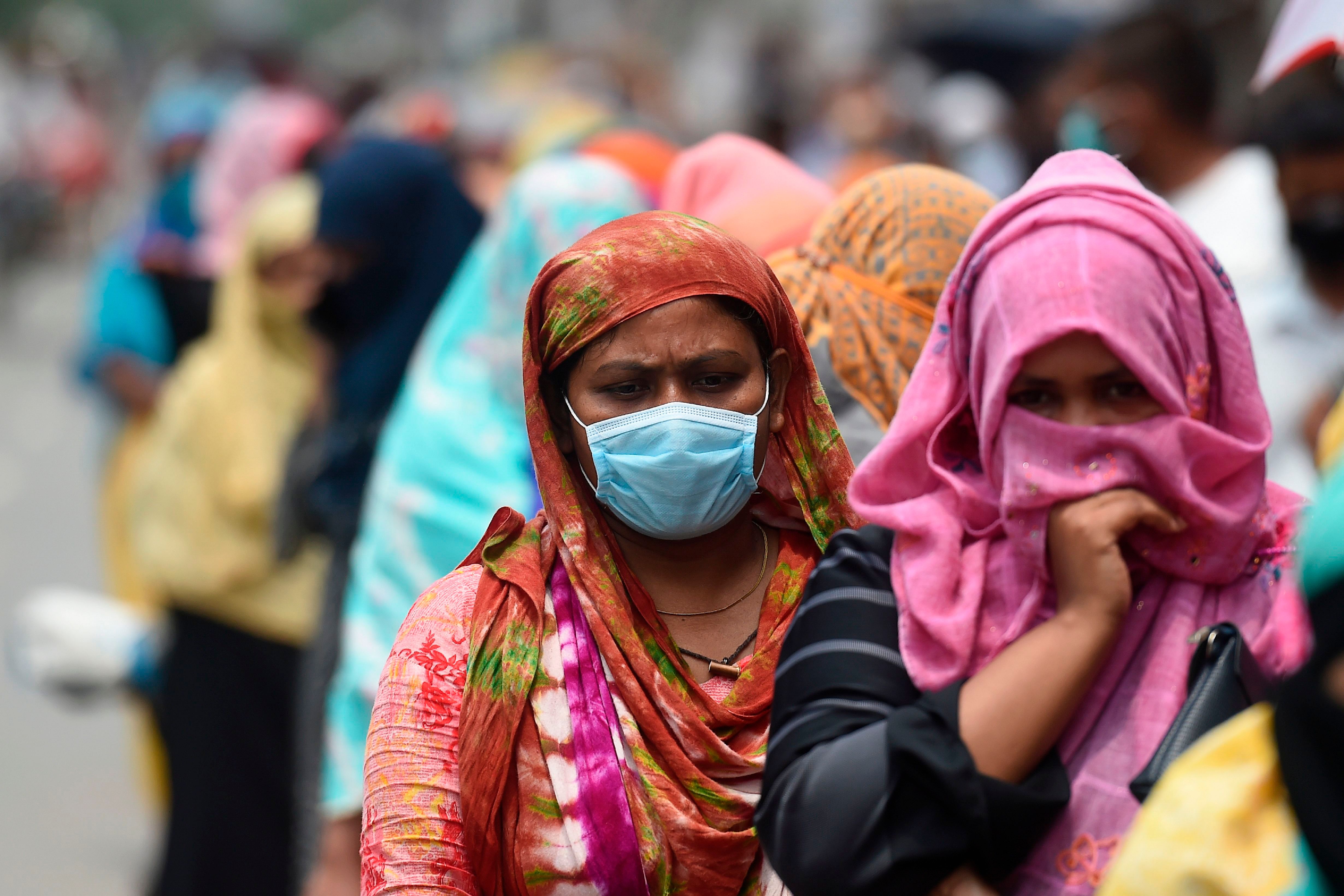 People queue to collect subsidised food items during a government-imposed nationwide lockdown as a preventive measure against the COVID-19 coronavirus, in Dhaka. (Credit: AFP Photo)