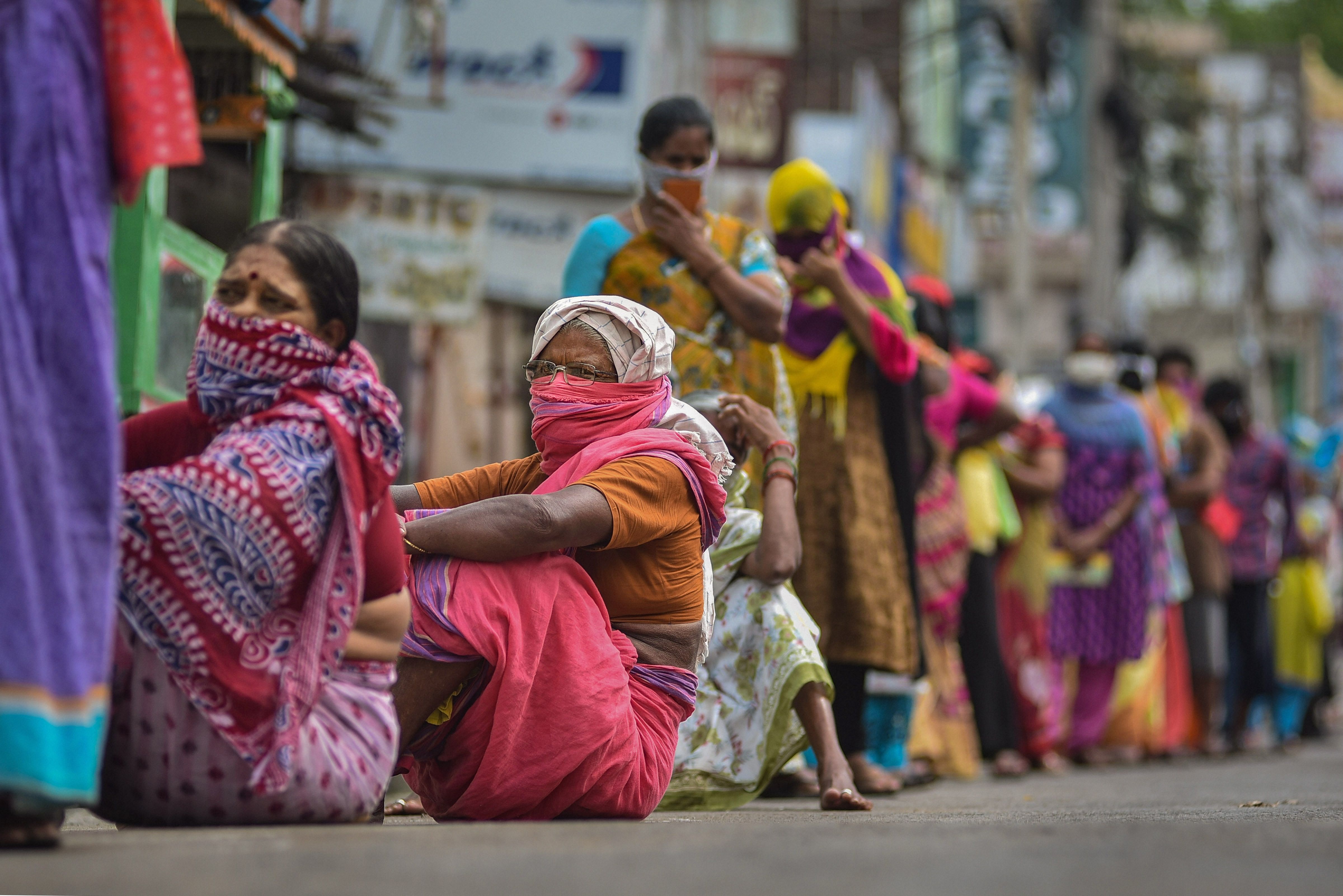 Vijayawada: Women wait outside a bank to withdraw money from their Jan-Dhan Yojana account during the nationwide lockdown. (Credit: PTI)