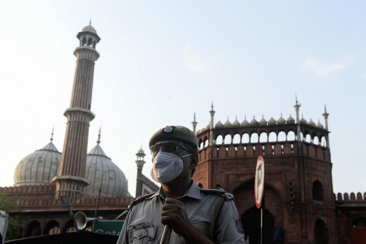A police officer stands guard outside Jama Masjid during a government-imposed nationwide lockdown as a preventive measure against the spread of the COVID-19 coronavirus, in the old quarters of New Delhi on April 25, 2020. Credit: AFP Photo