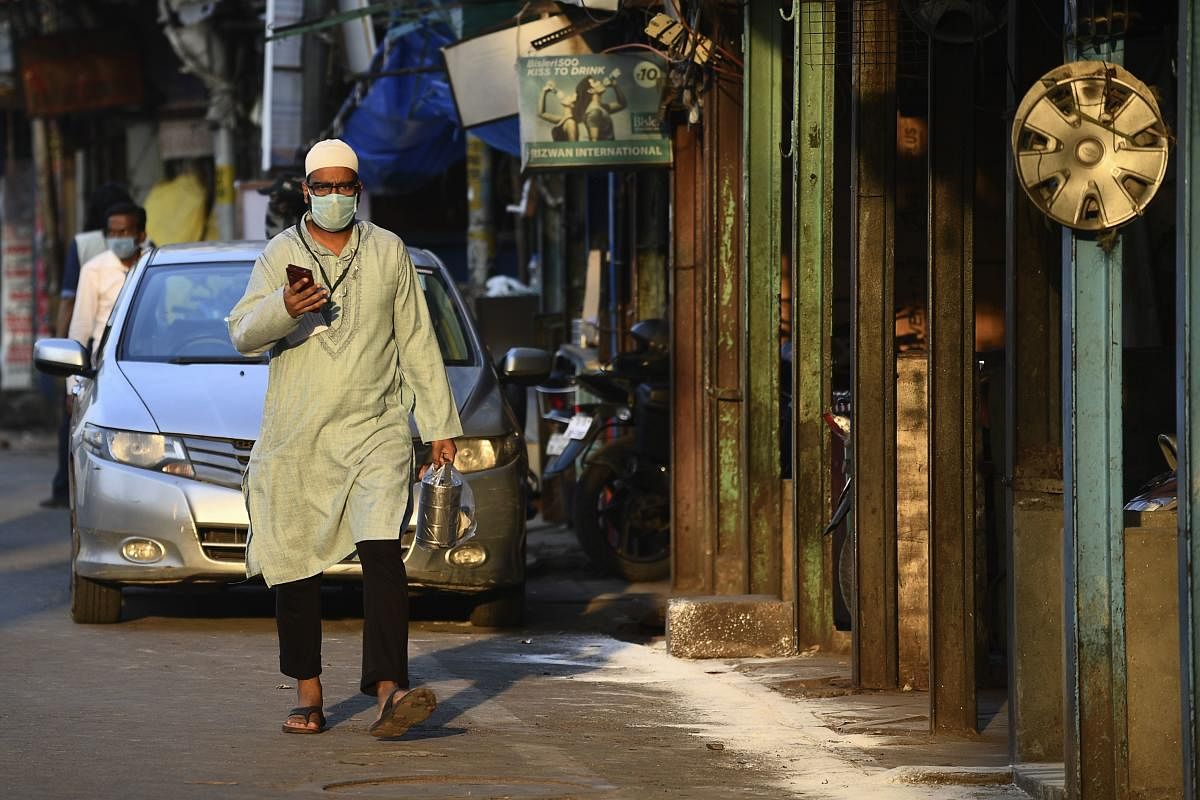 A resident wearing a facemask walks on a street during a government-imposed nationwide lockdown as a preventive measure against the spread of the COVID-19 coronavirus, in the old quarters of New Delhi on April 25, 2020. Credit: AFP Photo