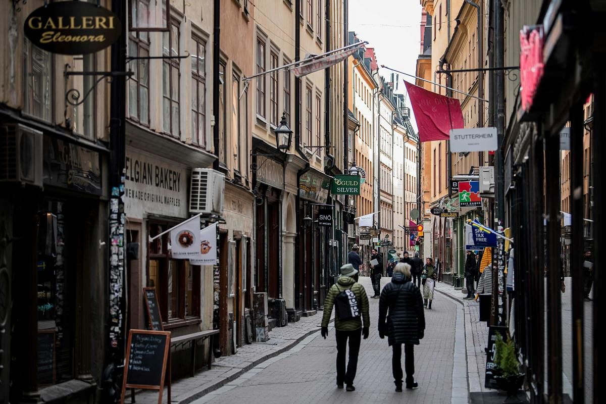 People walk in the main street of the old town in Stockholm, Sweden, while the rest of Europe is in lockdown (AFP Photo)