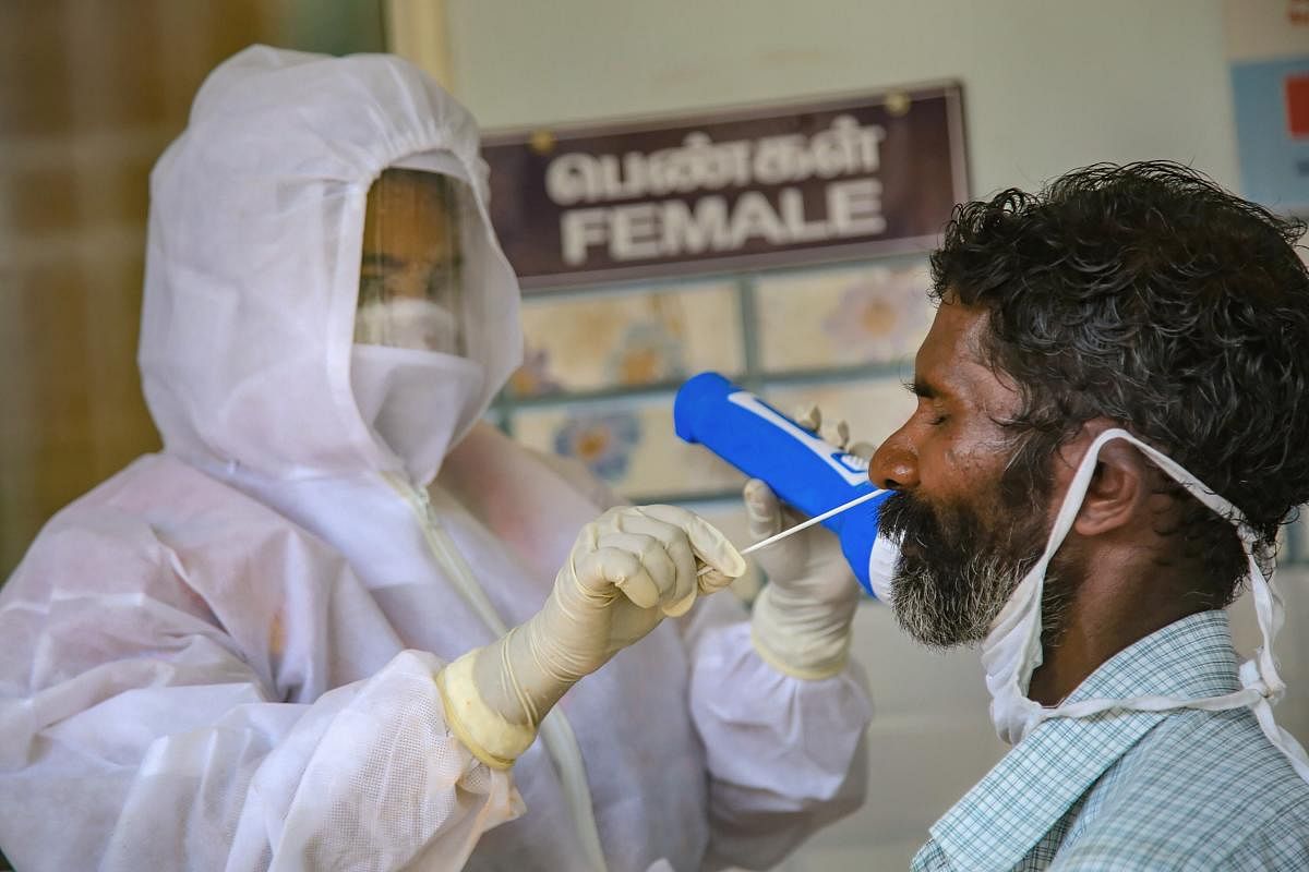 A health worker collects sample for COVID-19 tests (PTI Photo)