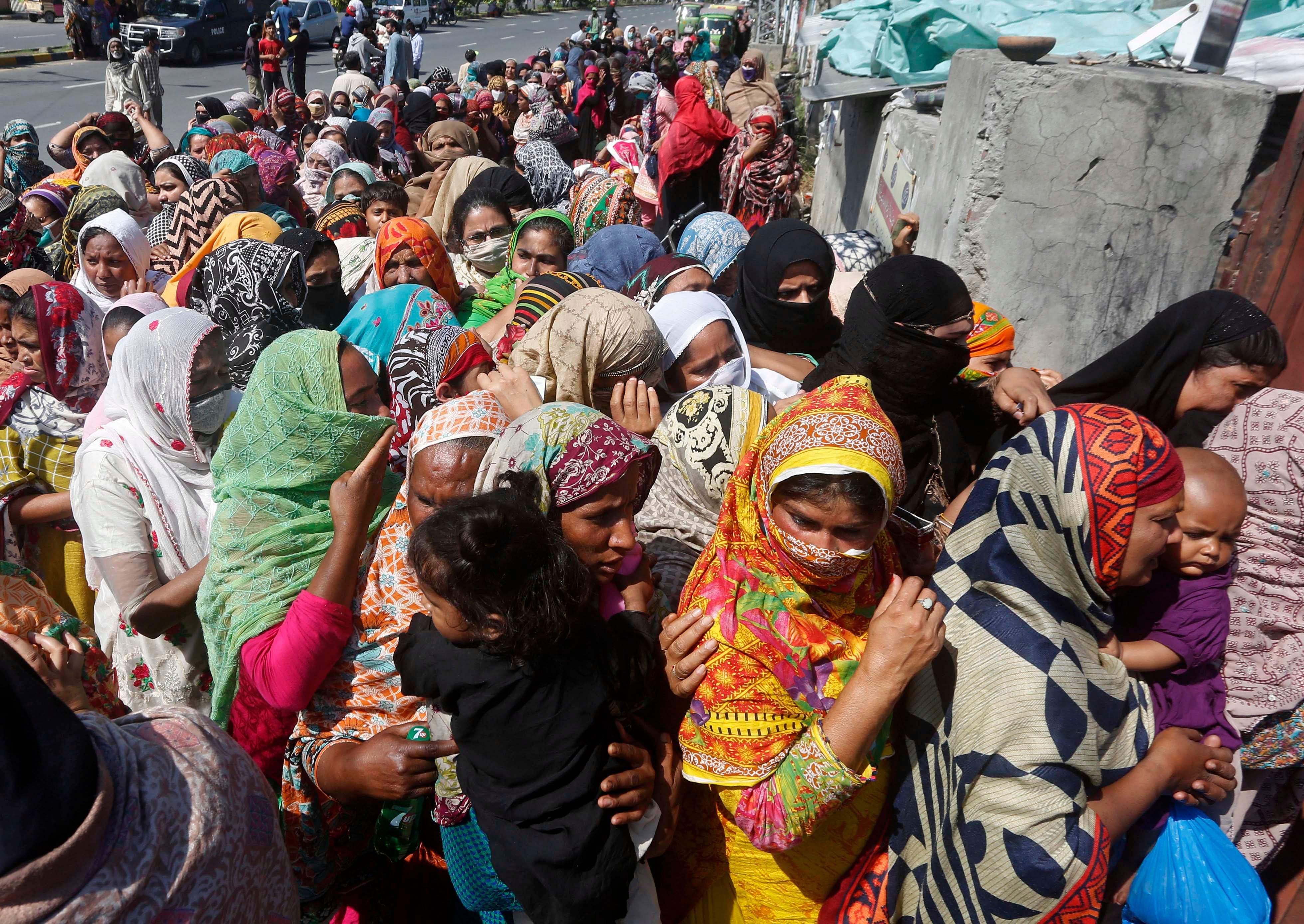 People wait to receive food assistance ahead of the Muslim fasting month of Ramadan, during a government-imposed nationwide lockdown to help contain the spread of the coronavirus. (AP Photo)