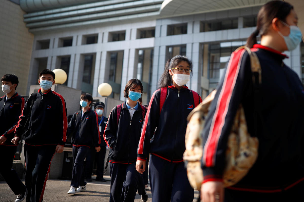 Students wearing face masks leave a school in Beijing, China as senior high school students in the Chinese capital returned to campus following the coronavirus disease (COVID-19) outbreak, April 27, 2020. Credit: Reuters Photo