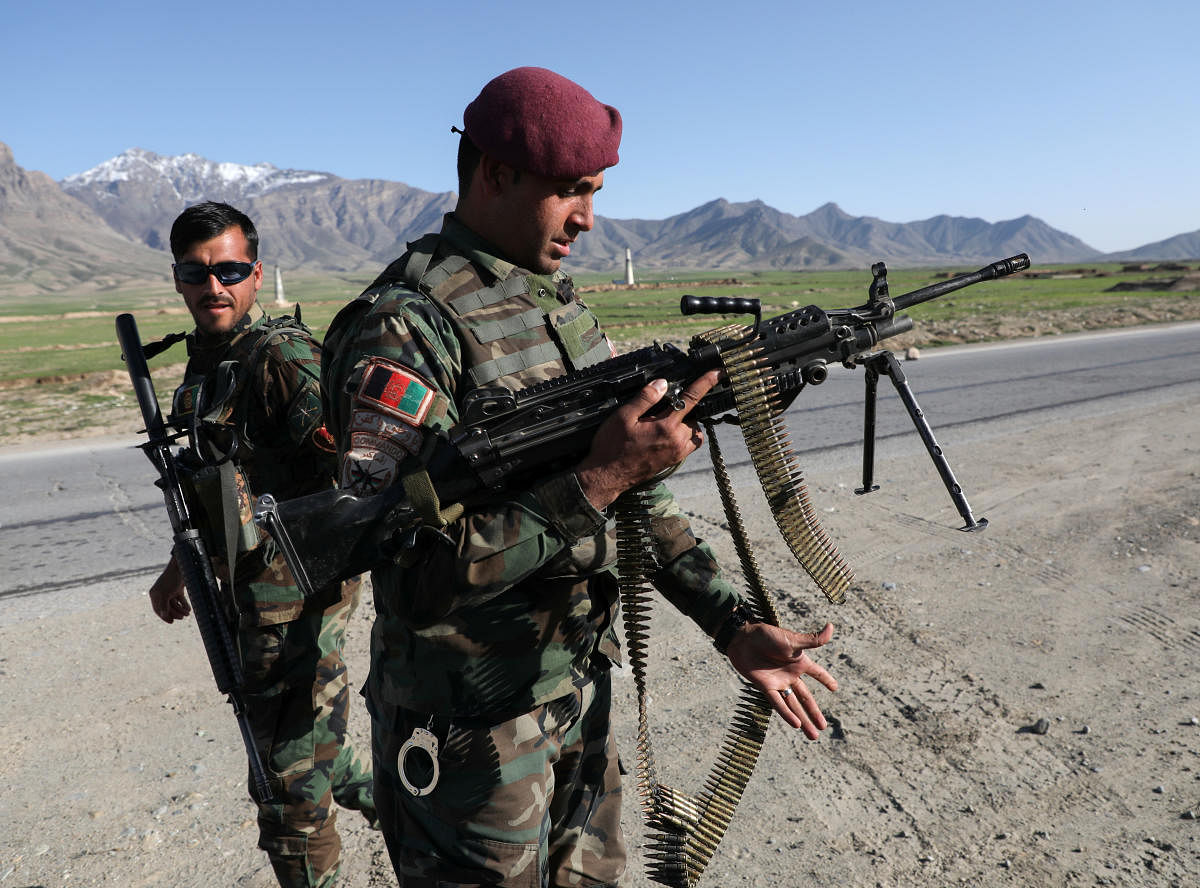 Afghan National Army (ANA) soldiers stand guard (Reuters Photo)