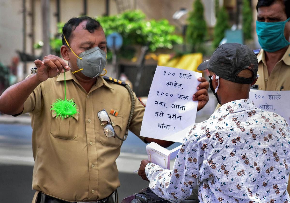  Policmen display placards to create awareness about COVID-19 during the nationwide lockdown (PTI Photo)