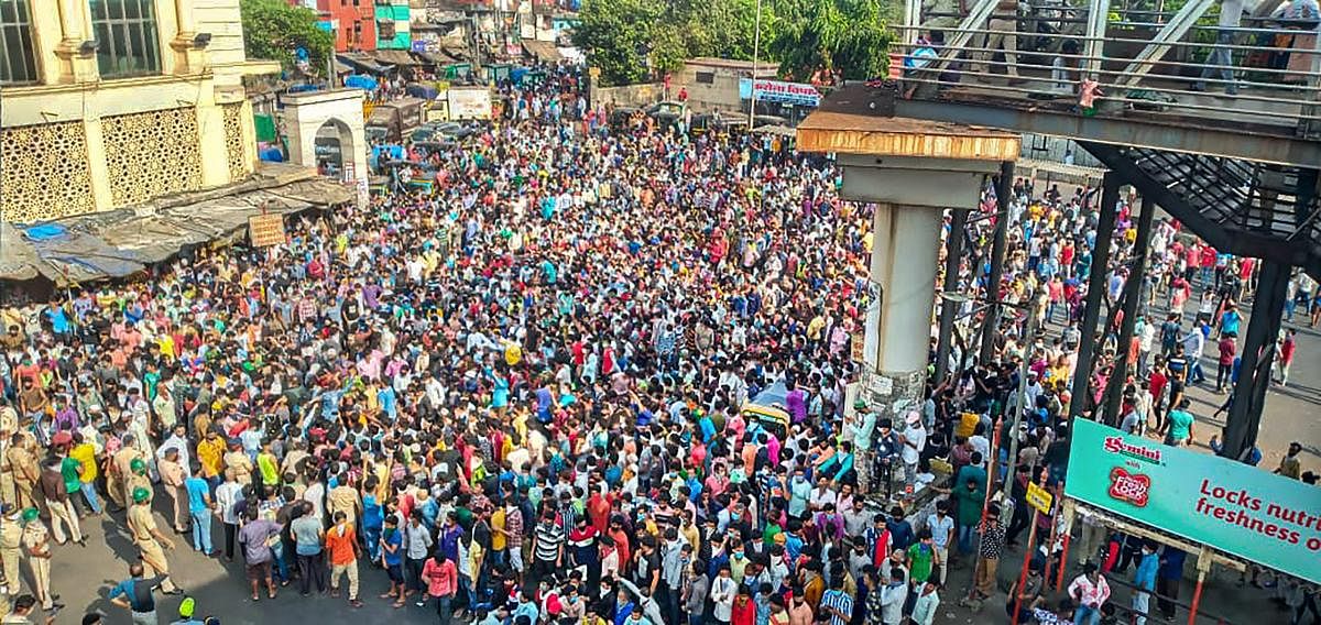  Migrant workers gather outside Bandra West Railway Station as they defy lockdown norms and request to leave for their native places after Prime Minister Narendra Modi had announced the extension of nationwide lockdown till May 3 in the wake of coronavirus pandemic, in Mumbai, Tuesday, April 14, 2020. Credit: PTI Photo