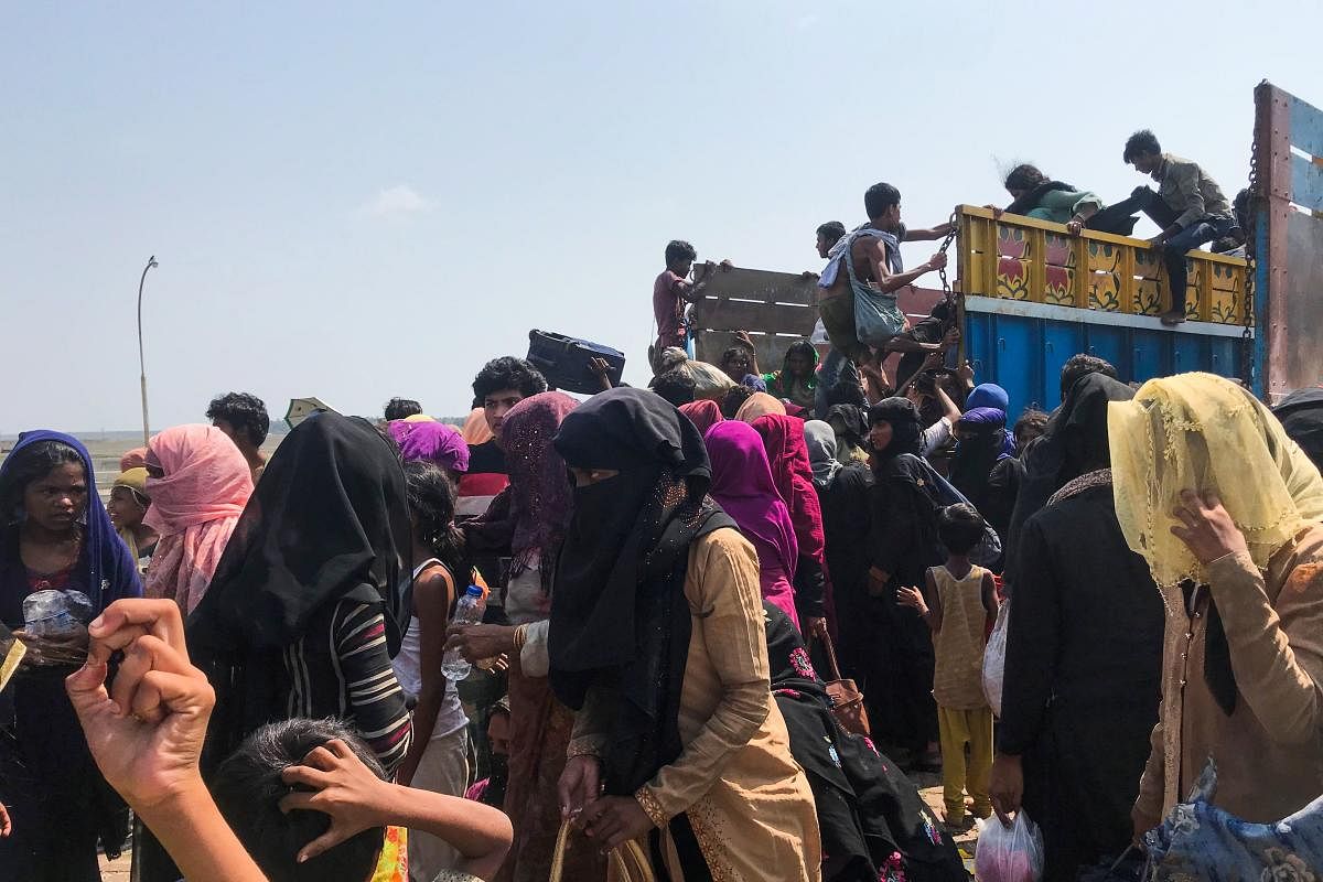 Rohingya refugees get in a truck following their arrival by a boat in Teknaf on 16 April 2020. Credit: AFP Photo