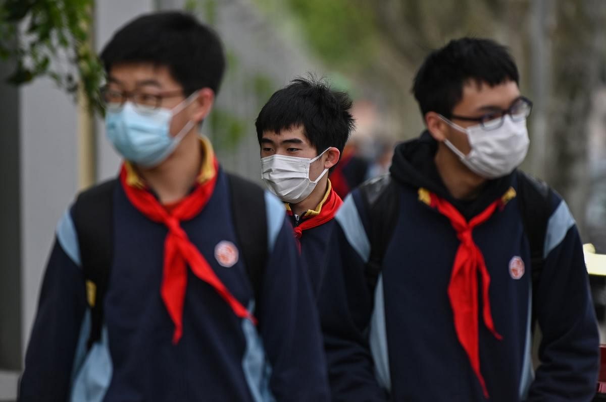 Students wearing face masks arrive at the Huayu Middle School in Shanghai on April 27, 2020. Credit: AFP Photo