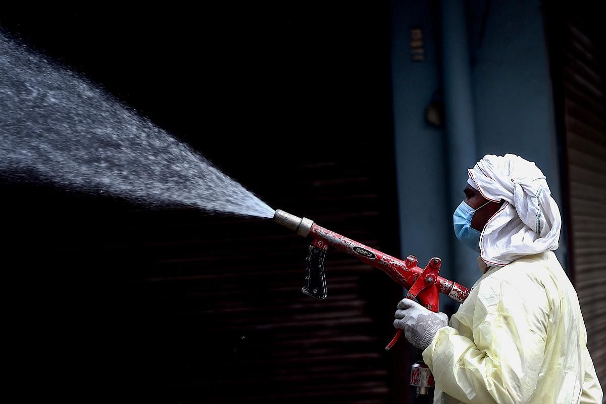 A municipal worker sprays disinfectant solution to sanitise a residential area during a government-imposed nationwide lockdown as a preventive measure against the spread of the COVID-19 coronavirus in Faridabad on April 15, 2020. Credit: AFP Photo