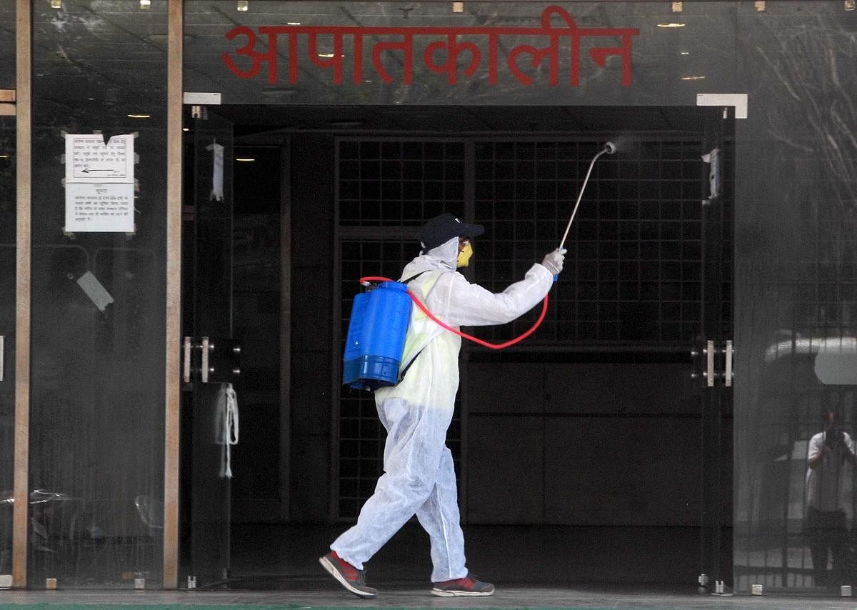 A health worker sanitises outside the emergency ward of Super Speciality Paediatric Hospital & Post Graduate Teaching Institute, during the nationwide lockdown to curb the spread of coronavirus, at Sec-30 in Noida, Tuesday, April 28, 2020. Credit: PTI Photo
