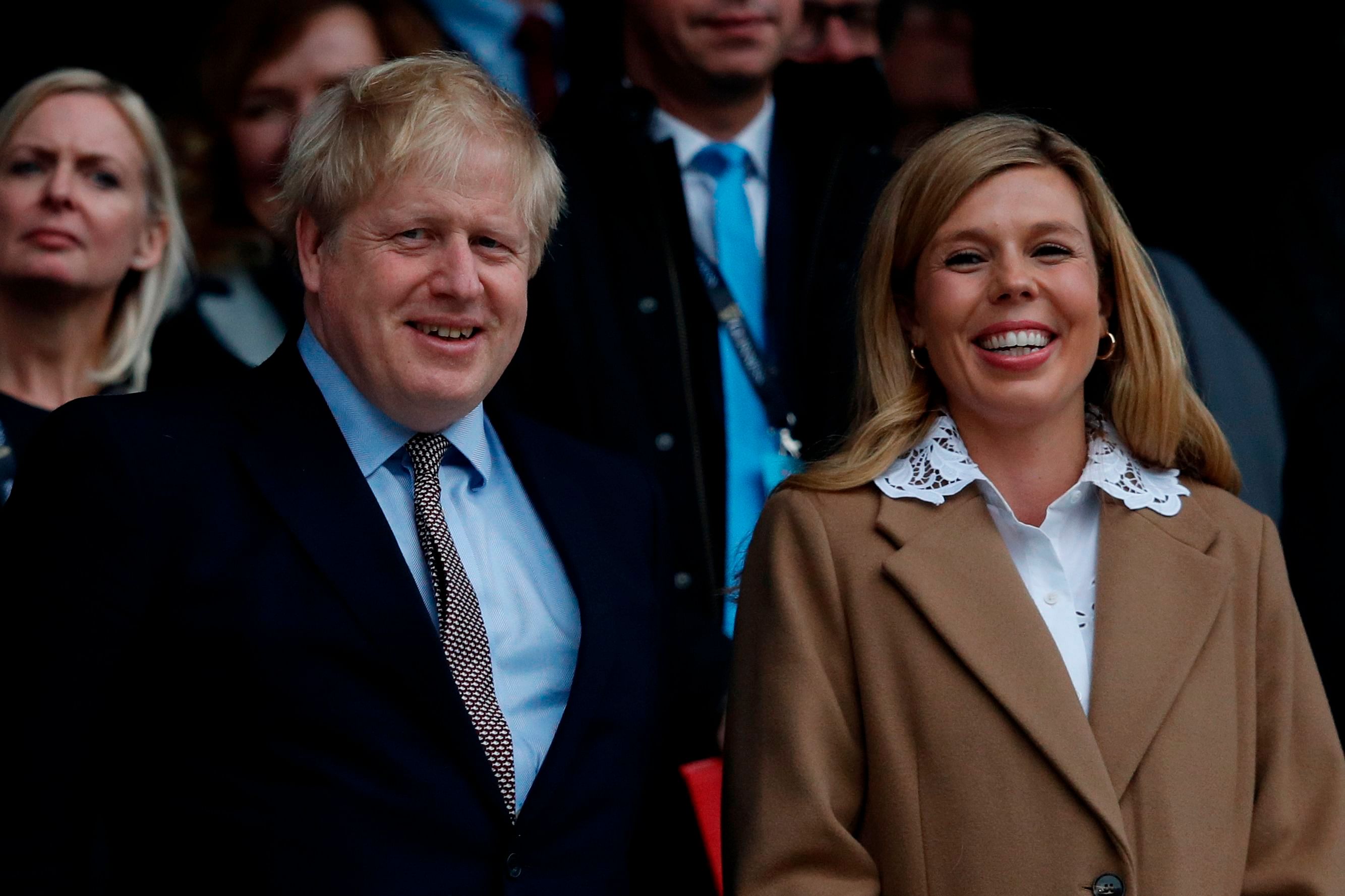 Britain's Prime Minister Boris Johnson (L) with his partner Carrie Symonds. (AFP Photo)