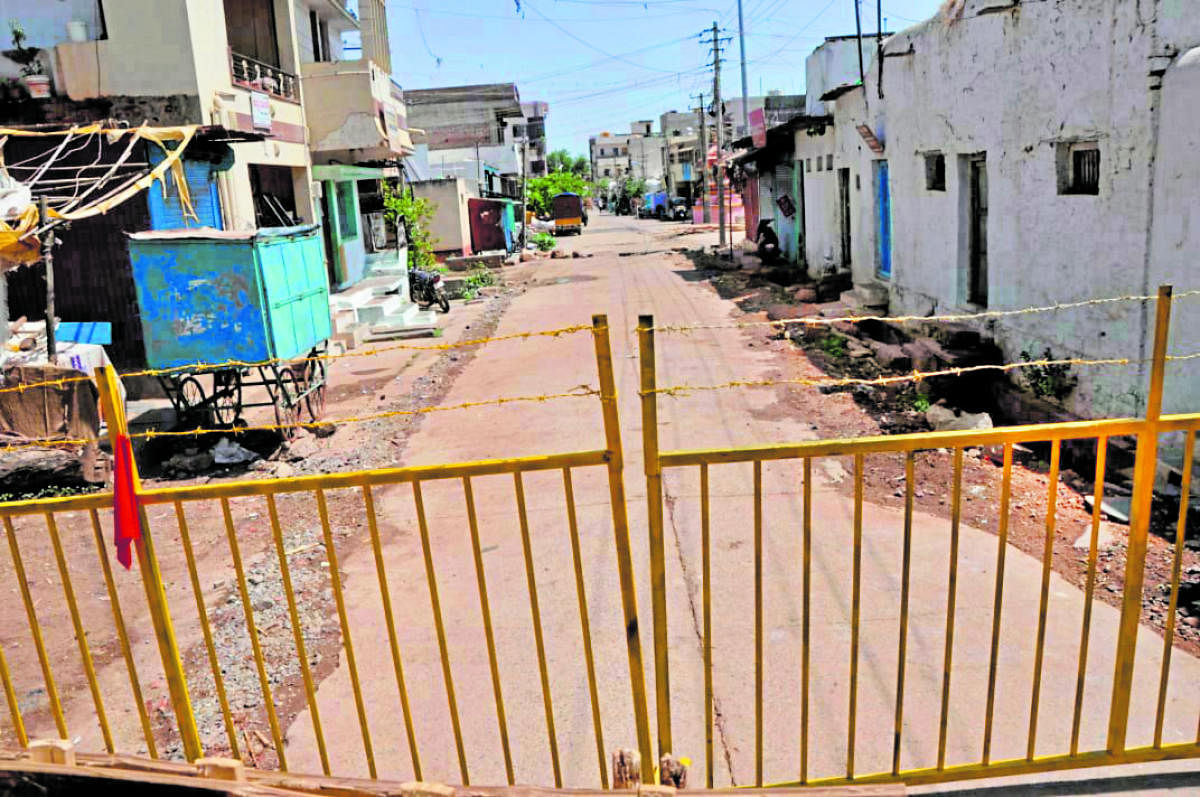 The street where a Covid-19 case was detected is barricaded in Gadag on Tuesday. DH Photo