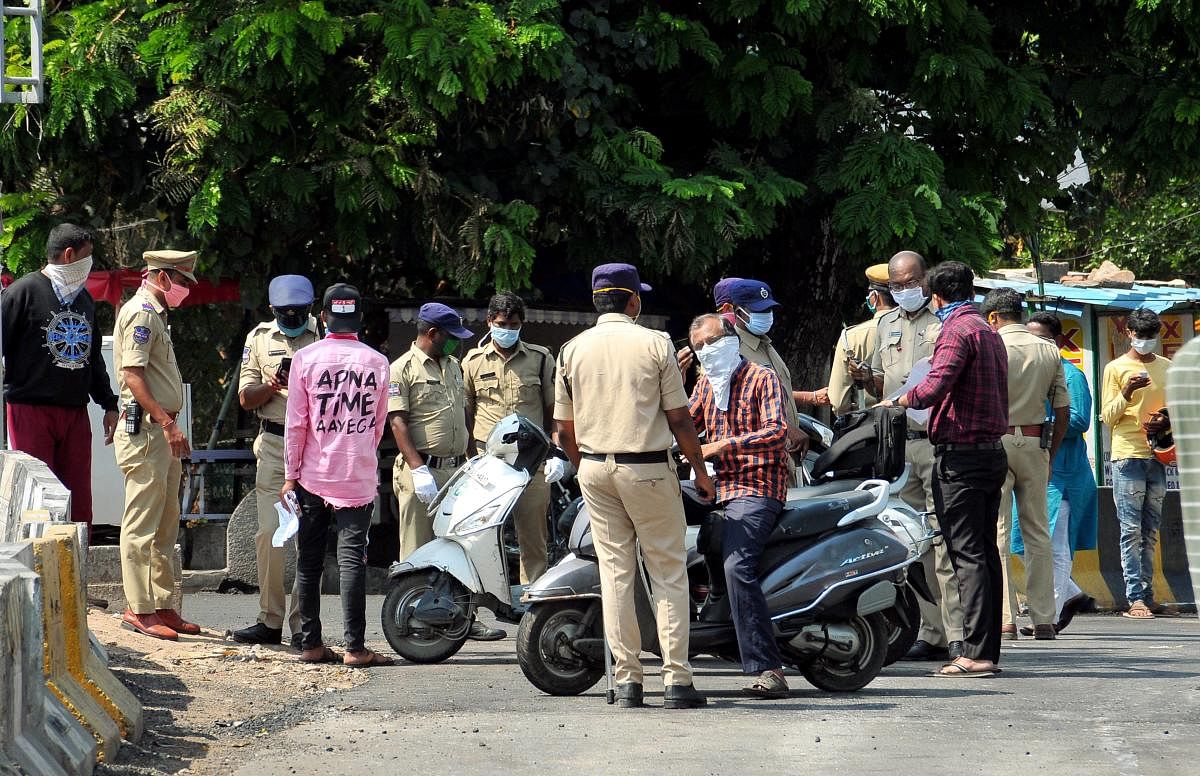  Police personnel question commuters for stepping out of their houses, during the nationwide lockdown to curb the spread of coronavirus, in Hyderabad, Thursday, April 23, 2020. (PTI Photo) 