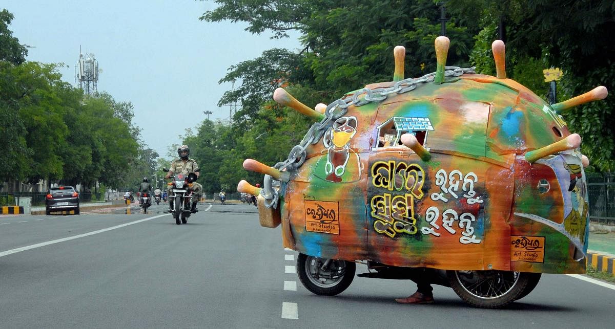 An artist designs his motorcycle on novel coronavirus theme to make people aware against the pandemic, during ongoing lockdown in Bhubaneswar, April 28, 2020. (PTI Photo)